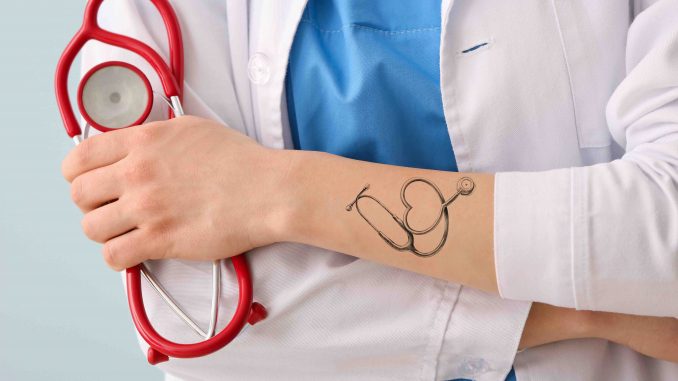 Male doctor with tattoo of stethoscope on arm, closeup Stock Photo - Alamy